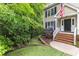 Charming two-story house with brick steps and lush greenery, accented by mature trees and a manicured lawn at 5805 Bayberry Ln, Raleigh, NC 27612
