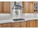 Gourmet kitchen with stainless vent hood, gas range, custom wood cabinets and white countertops at 5805 Bayberry Ln, Raleigh, NC 27612