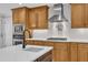 Kitchen with granite counters, stainless appliances, custom cabinets and gas range stovetop at 5805 Bayberry Ln, Raleigh, NC 27612