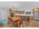 Open kitchen, dining and eating area with custom cabinets, stainless appliances and hardwood floors at 5805 Bayberry Ln, Raleigh, NC 27612