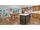 Open kitchen and breakfast nook with an island, wood cabinets, stainless appliances and hardwood floors at 5805 Bayberry Ln, Raleigh, NC 27612