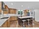 Large kitchen with island seating, stainless appliances, custom cabinets and hardwood floors at 5805 Bayberry Ln, Raleigh, NC 27612