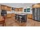 A spacious kitchen featuring custom cabinetry, stainless steel appliances, and an island with bar seating at 5805 Bayberry Ln, Raleigh, NC 27612
