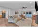 Open concept living room with hardwood floors, brick fireplace, comfortable seating, and bright windows at 5805 Bayberry Ln, Raleigh, NC 27612