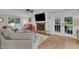 Cozy living room with brick fireplace, hardwood floors, bright windows and glass paneled doors at 5805 Bayberry Ln, Raleigh, NC 27612