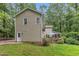 View of the home's rear exterior, highlighting the deck, small balcony, and back entrance at 5805 Bayberry Ln, Raleigh, NC 27612