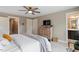 Bedroom with ceiling fan, tv, a dresser and access to the bathroom at 586 Great Ridge Pkwy, Chapel Hill, NC 27517