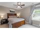 Bedroom featuring a wooden bed frame, fan, and a window with natural light at 586 Great Ridge Pkwy, Chapel Hill, NC 27517