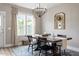 Bright dining room with natural light, wood table, and decorative mirror at 586 Great Ridge Pkwy, Chapel Hill, NC 27517