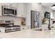 Modern kitchen with stainless appliances, white cabinets, and subway tile backsplash at 586 Great Ridge Pkwy, Chapel Hill, NC 27517