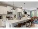 Spacious kitchen with stainless steel appliances, white cabinets, and a large island with seating at 586 Great Ridge Pkwy, Chapel Hill, NC 27517