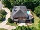 An aerial view showcasing the property's roof, driveway and outdoor pool at 6217 Battleford Dr, Raleigh, NC 27612