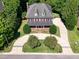Aerial view of traditional brick home with circular drive and mature landscaping at 6217 Battleford Dr, Raleigh, NC 27612