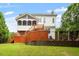 Back of house featuring a screened porch, wooden deck, backyard, and dark metal fence at 6217 Battleford Dr, Raleigh, NC 27612
