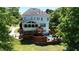 Expansive backyard featuring a pool, screened porch, lush lawn, and mature trees creating a private oasis at 6217 Battleford Dr, Raleigh, NC 27612