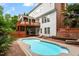 Backyard pool area with a brick patio and multi-level deck attached to a white brick home at 6217 Battleford Dr, Raleigh, NC 27612