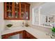 Elegant bar area with custom cabinetry, marble countertops, and decorative glassware at 6217 Battleford Dr, Raleigh, NC 27612