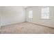 A basic bedroom with carpet, two windows, and white trim is ready for customization at 6217 Battleford Dr, Raleigh, NC 27612