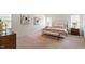 A bright bedroom features neutral decor, bench, artwork, and multiple windows for natural light at 6217 Battleford Dr, Raleigh, NC 27612