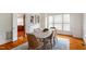 Open dining room with modern decor, wainscoting, and wood floors at 6217 Battleford Dr, Raleigh, NC 27612