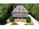 Beautiful brick home featuring a covered porch, well-manicured lawn, and mature trees, providing a serene and inviting atmosphere at 6217 Battleford Dr, Raleigh, NC 27612