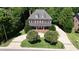 Stately brick home with a circular driveway, manicured landscaping, and a welcoming front porch, offering great curb appeal at 6217 Battleford Dr, Raleigh, NC 27612