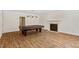 Spacious game room with hardwood floors featuring a fireplace and pool table with cover at 6217 Battleford Dr, Raleigh, NC 27612