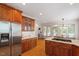 Bright kitchen featuring wood cabinets, stainless steel refrigerator, and breakfast nook at 6217 Battleford Dr, Raleigh, NC 27612