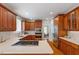 Open kitchen with wood cabinets, stainless steel appliances, and eat-in area at 6217 Battleford Dr, Raleigh, NC 27612