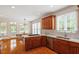 Well-lit kitchen with stainless appliances, wood cabinetry, and open layout to dining area at 6217 Battleford Dr, Raleigh, NC 27612