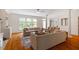 Comfortable living room with hardwood flooring, large windows, and open floor plan at 6217 Battleford Dr, Raleigh, NC 27612