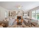 Bright living room featuring a fireplace, built-in shelving, hardwood floors, and comfortable seating at 6217 Battleford Dr, Raleigh, NC 27612