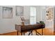 Stylish home office featuring a modern desk, built-in shelves, and hardwood floors at 6217 Battleford Dr, Raleigh, NC 27612