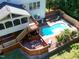 Backyard featuring a beautiful in-ground pool, deck, and lush landscaping at 6217 Battleford Dr, Raleigh, NC 27612