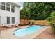 Backyard oasis featuring a sparkling in-ground pool with a brick-paved deck and mature landscaping at 6217 Battleford Dr, Raleigh, NC 27612