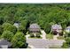 An aerial view of a neighborhood with traditional homes surrounded by trees at 6217 Battleford Dr, Raleigh, NC 27612
