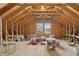 Attic space with exposed wooden beams, plywood walls, and various stored items at 6444 Kit Creek Rd, Morrisville, NC 27560