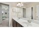 Neutral bathroom featuring double sinks, brown cabinets, and a view into an adjacent bedroom at 6444 Kit Creek Rd, Morrisville, NC 27560