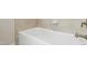 Clean white tub with tile surround, offering a relaxing space at 6444 Kit Creek Rd, Morrisville, NC 27560