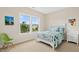 Cozy bedroom featuring a bed with colorful bedding and a view from a large window at 6444 Kit Creek Rd, Morrisville, NC 27560