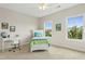 Bright bedroom featuring two windows, a white desk, and a white bed with colorful bedding at 6444 Kit Creek Rd, Morrisville, NC 27560