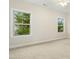 Bright bedroom with carpet, neutral walls and large windows for ample natural light at 6444 Kit Creek Rd, Morrisville, NC 27560