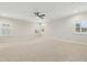 Spacious bonus room with large windows, ceiling fan, and neutral carpet flooring at 6444 Kit Creek Rd, Morrisville, NC 27560