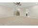 Large bonus room features a staircase, carpeted floor, and bright, natural light at 6444 Kit Creek Rd, Morrisville, NC 27560