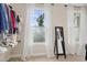 Bright walk-in closet with a mirror, built-in shelves, and natural light from the large window at 6444 Kit Creek Rd, Morrisville, NC 27560