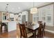 Bright dining room with wood table, seats for six, and natural light from plantation shutters at 6444 Kit Creek Rd, Morrisville, NC 27560