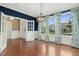 Dining room featuring hardwood floors, large windows, modern chandelier, and opening to the foyer at 6444 Kit Creek Rd, Morrisville, NC 27560