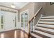 Bright foyer with hardwood floors, staircase and entry doors with transom windows allowing natural light at 6444 Kit Creek Rd, Morrisville, NC 27560