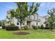 Two-story home with lawn, beautiful landscaping, stone steps and green siding providing an inviting exterior at 6444 Kit Creek Rd, Morrisville, NC 27560