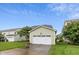Detached garage with a white door, green siding, and a concrete driveway at 6444 Kit Creek Rd, Morrisville, NC 27560